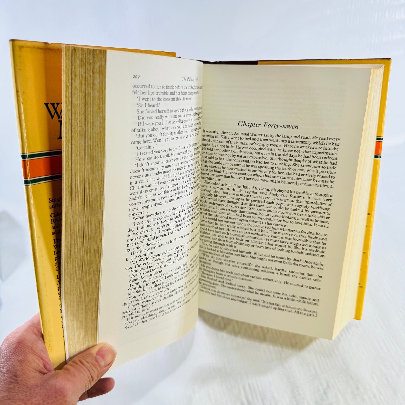 Open pages showing The Painted Veil text and binding