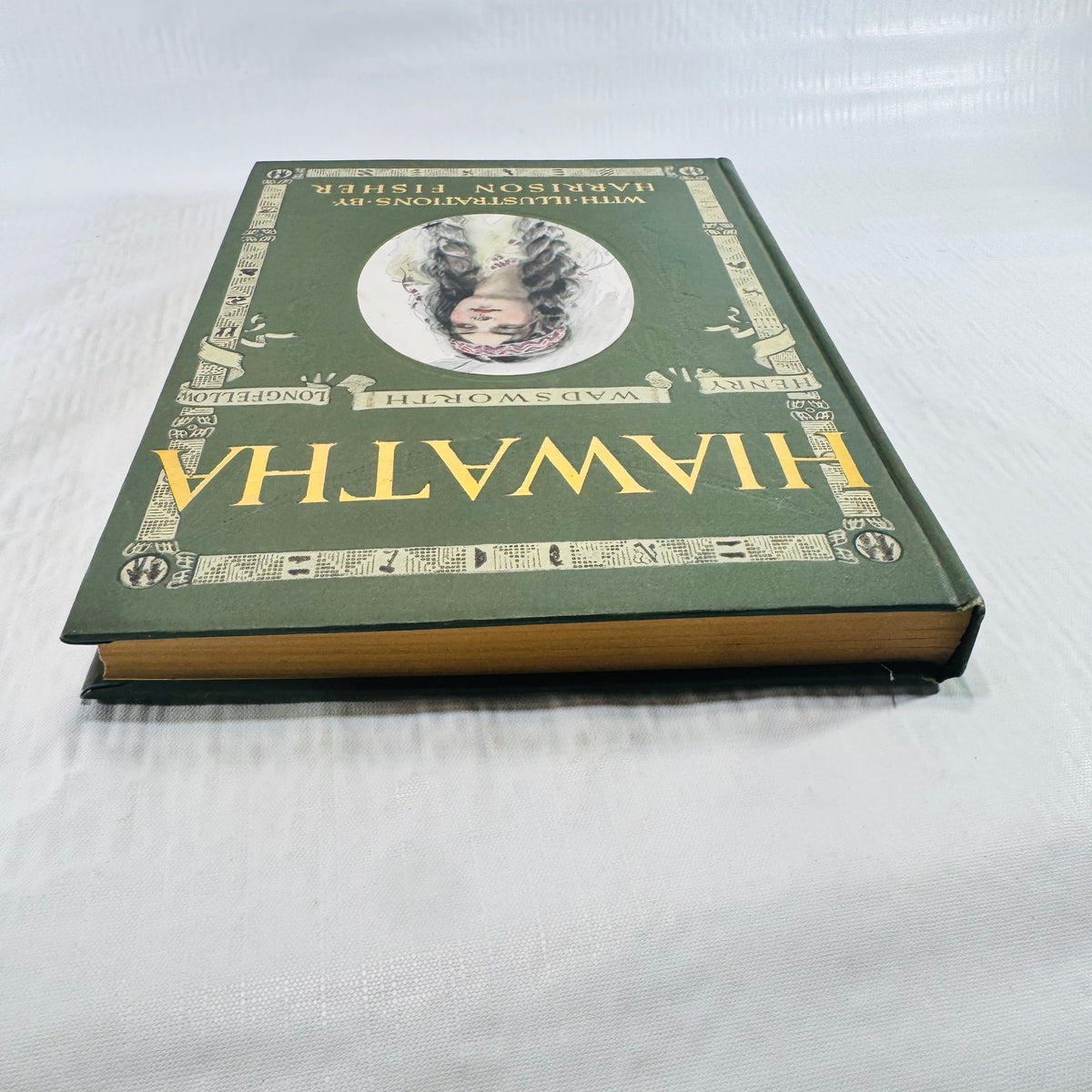 Book lying flat showing the front cover and tanned page edges