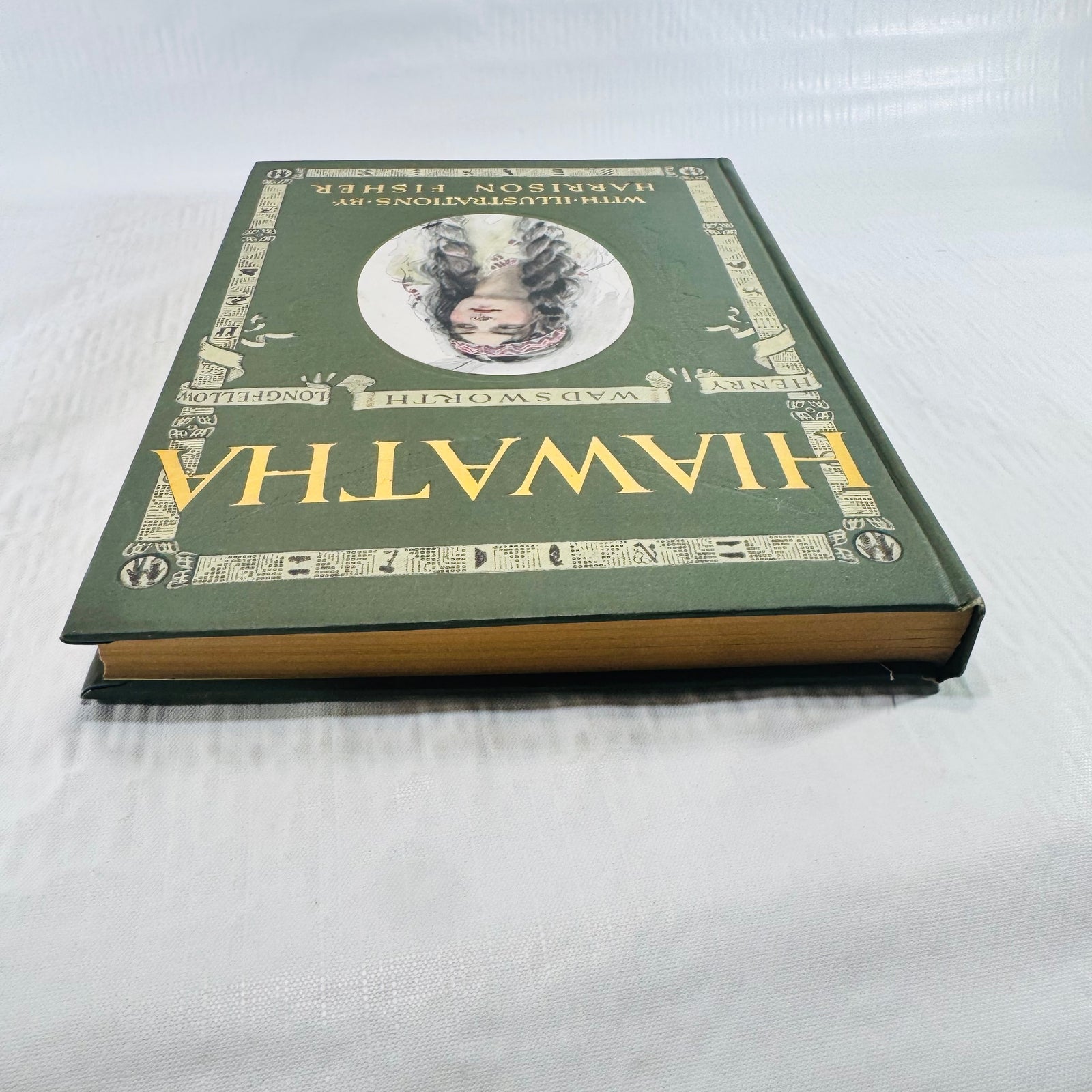 Book lying flat showing the front cover and tanned page edges
