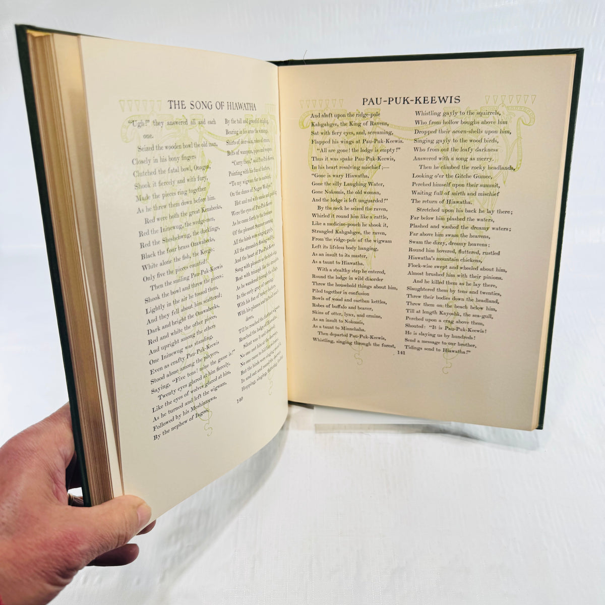 Pau-Puk-Keewis passage on pages 140 and 141 with green ornamental borders