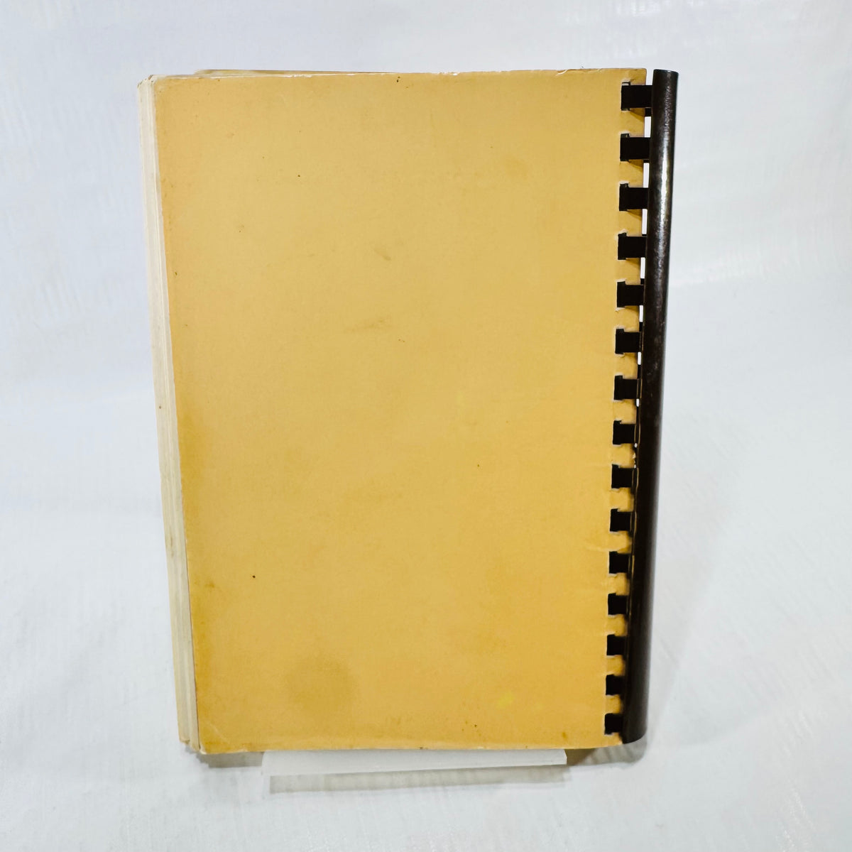 Back cover of the 1985 St. Helen School cookbook with brown plastic comb binding