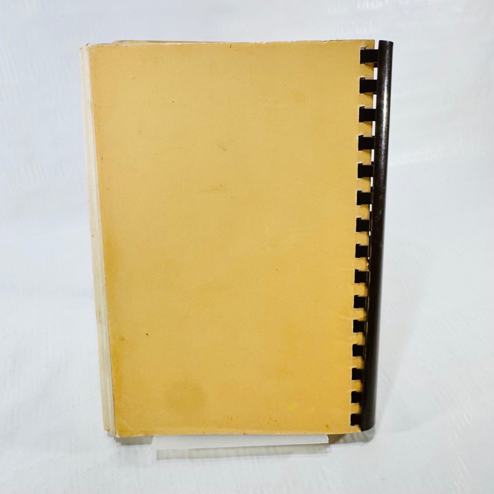 Back cover of the 1985 St. Helen School cookbook with brown plastic comb binding