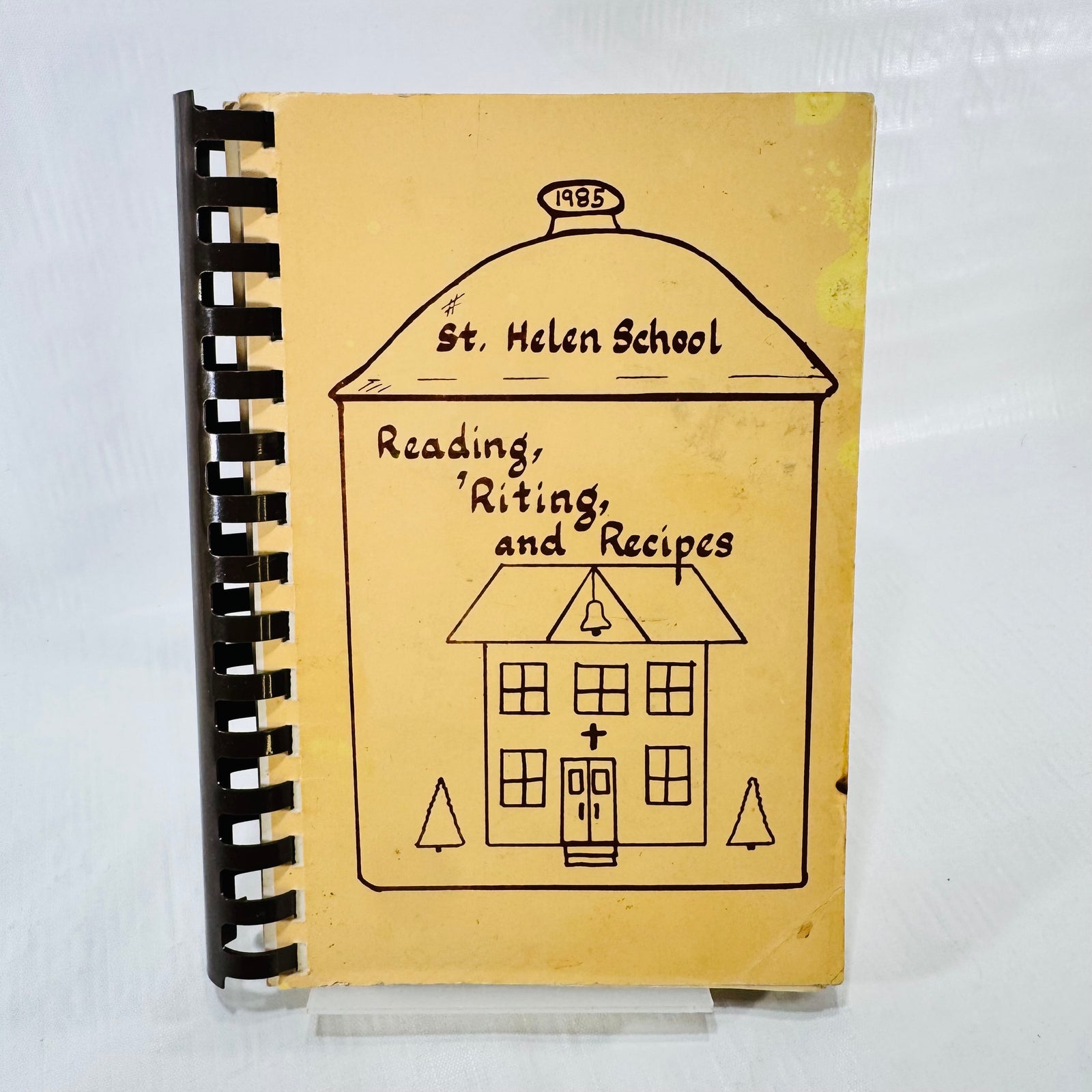 St. Helen School Reading Riting and Recipes 1985 cookbook front cover with schoolhouse drawing