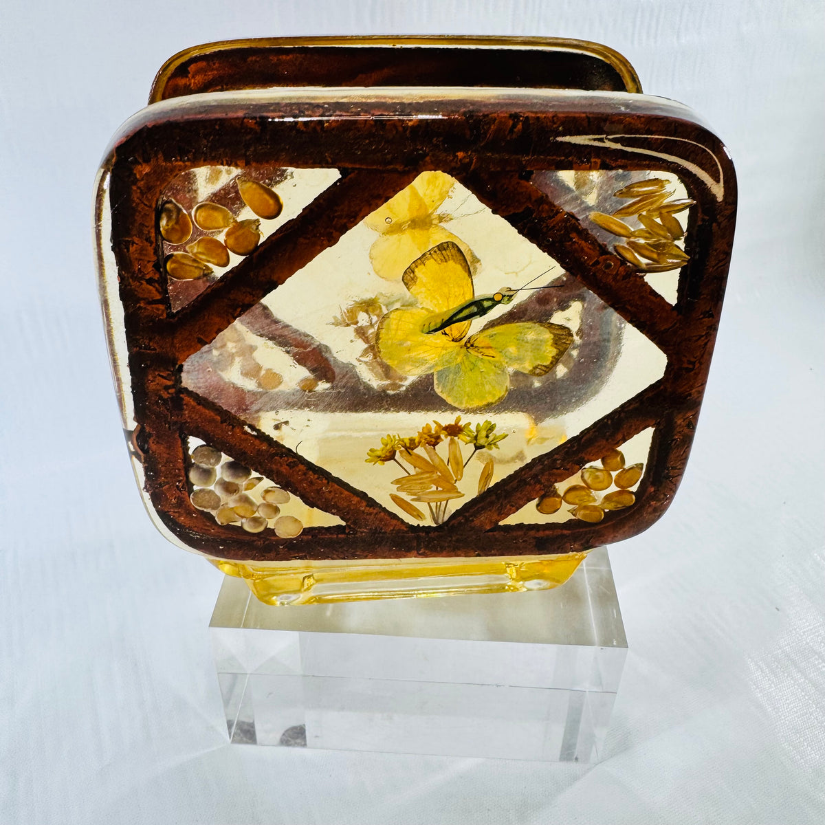 Vintage 1970s lucite resin napkin holder with embedded yellow butterfly on a clear stand