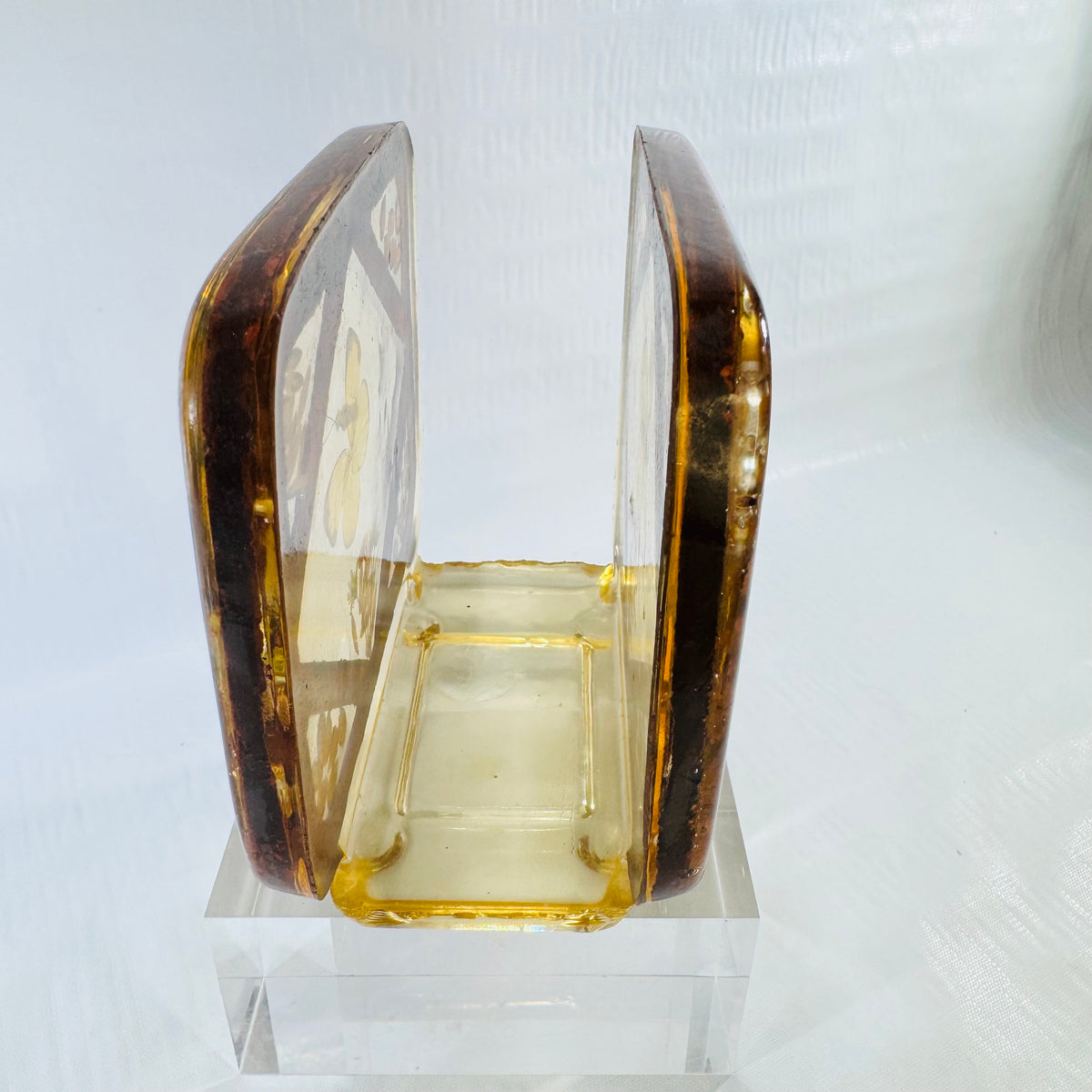 Angled view into the open slot of the lucite resin napkin and letter holder