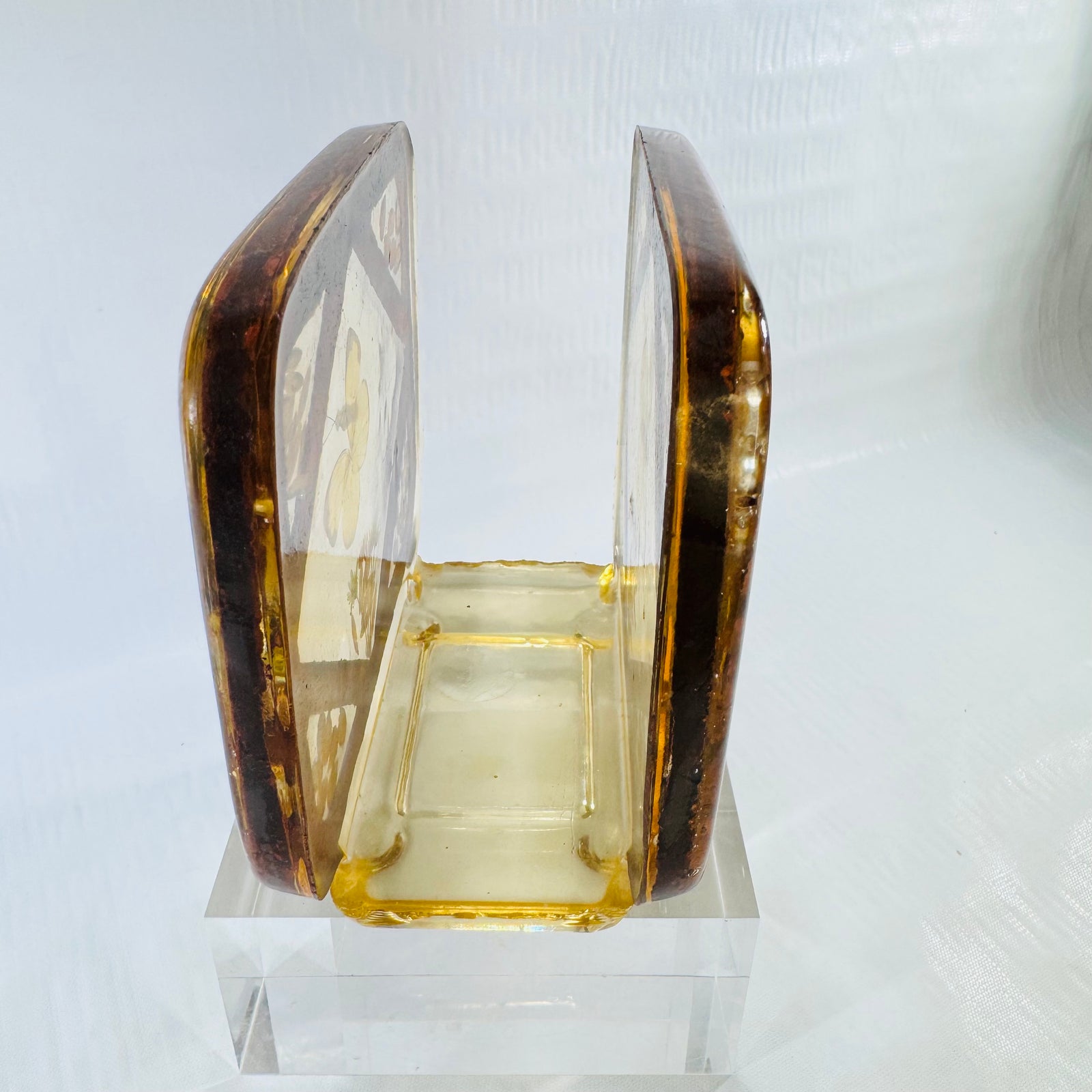Vintage 1970s lucite resin napkin holder with embedded yellow butterfly on a clear stand