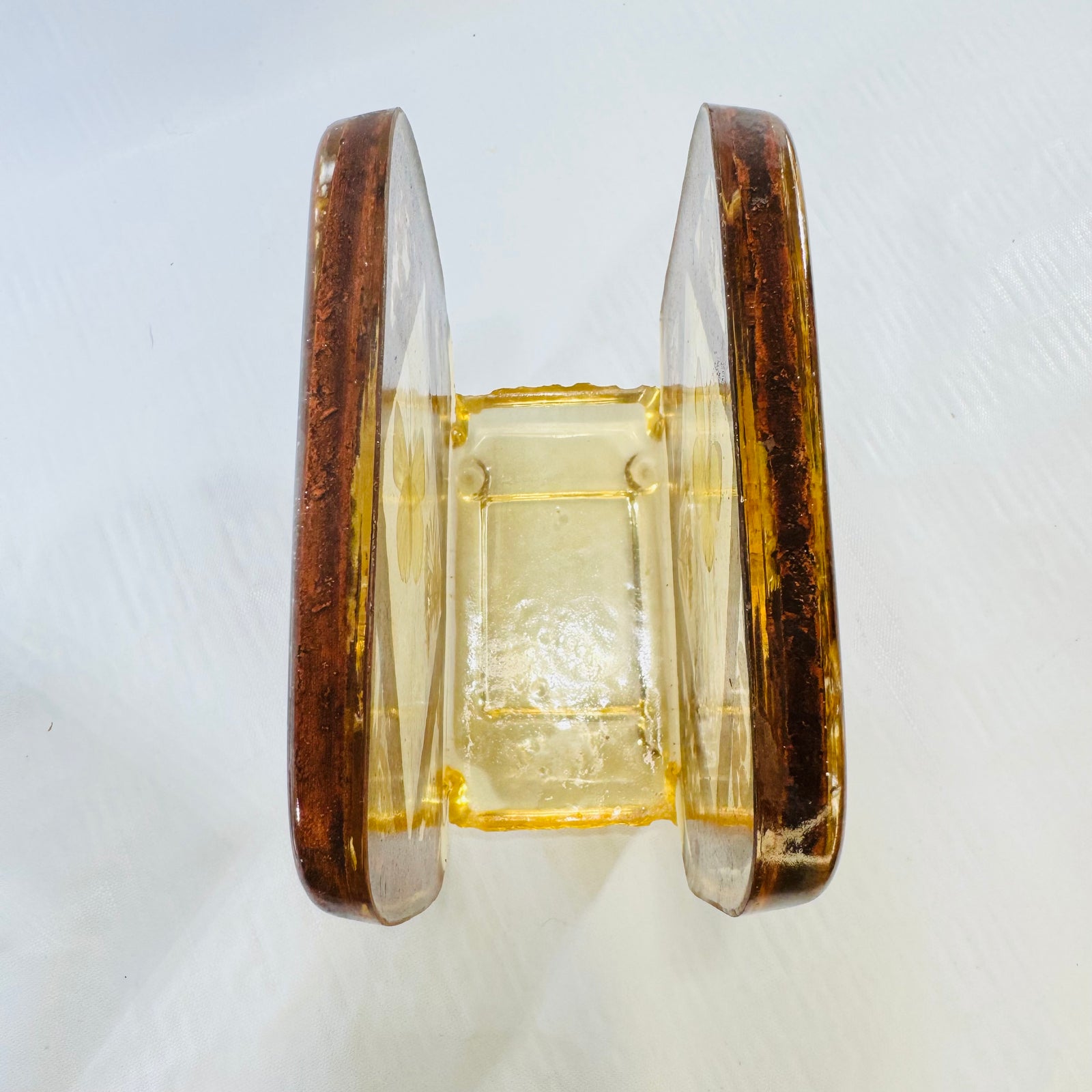Top-down view into the slot of the vintage lucite butterfly napkin holder