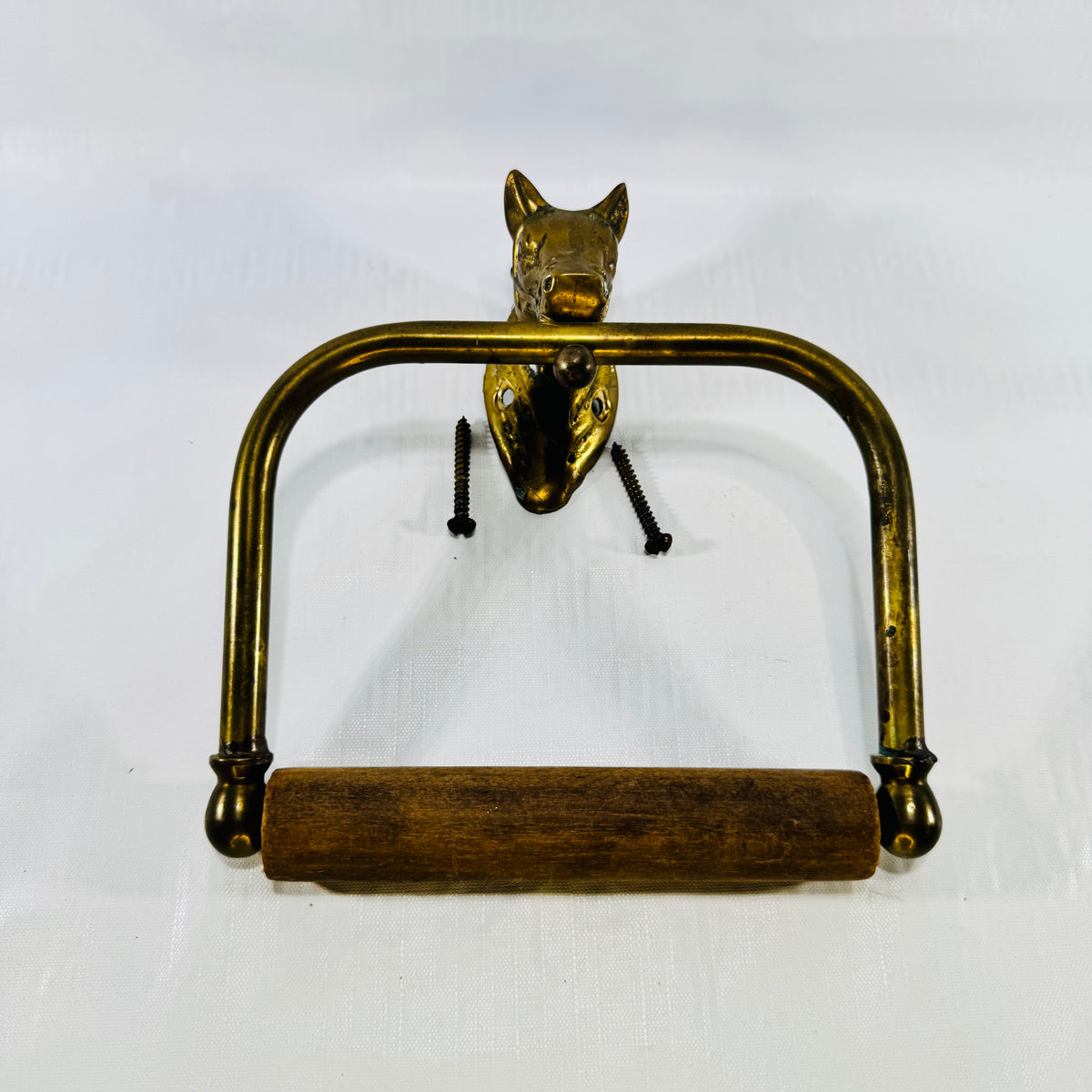 Vintage brass horse head toilet paper holder with wood roller and original screws, front view