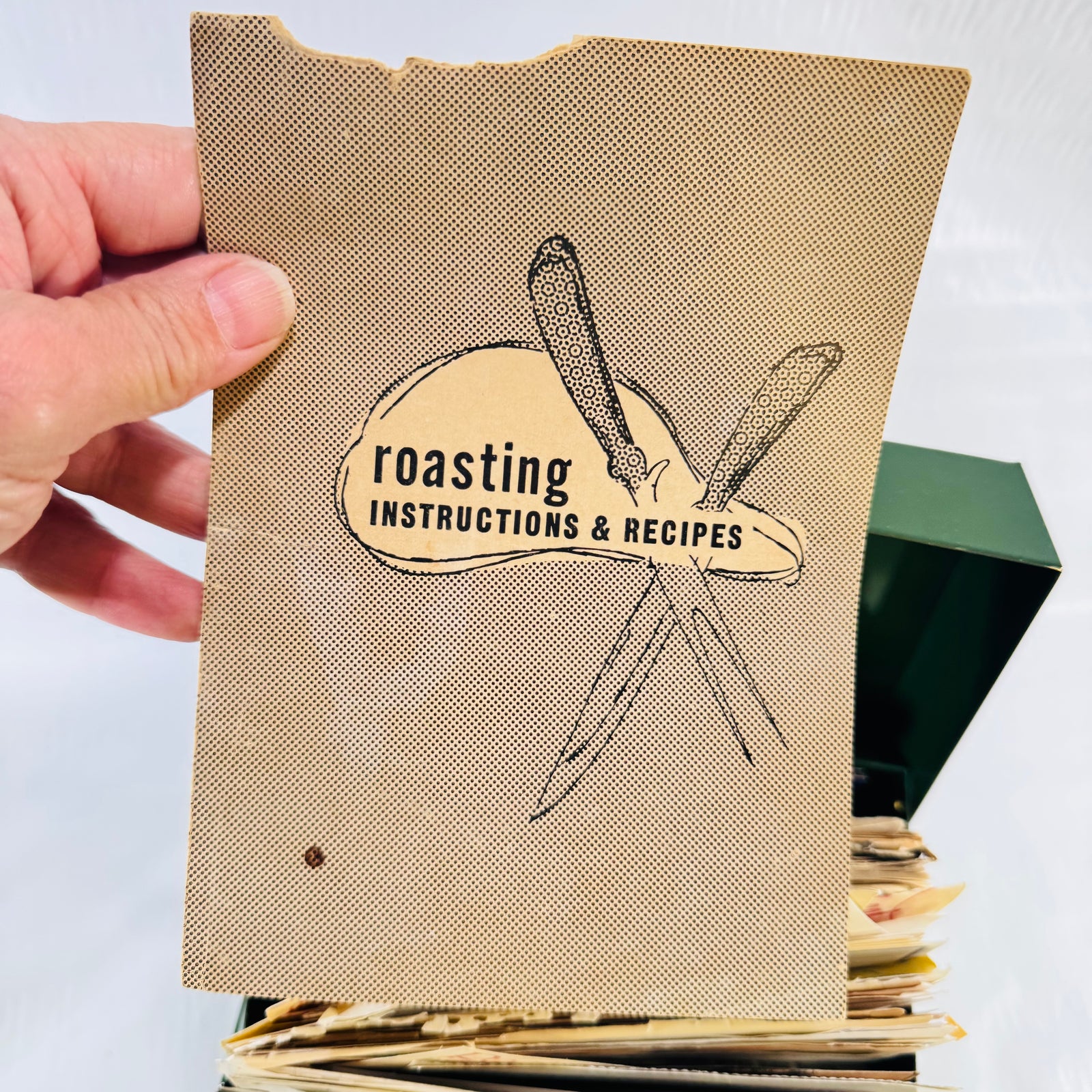 Roasting Instructions and Recipes booklet held up from the recipe box