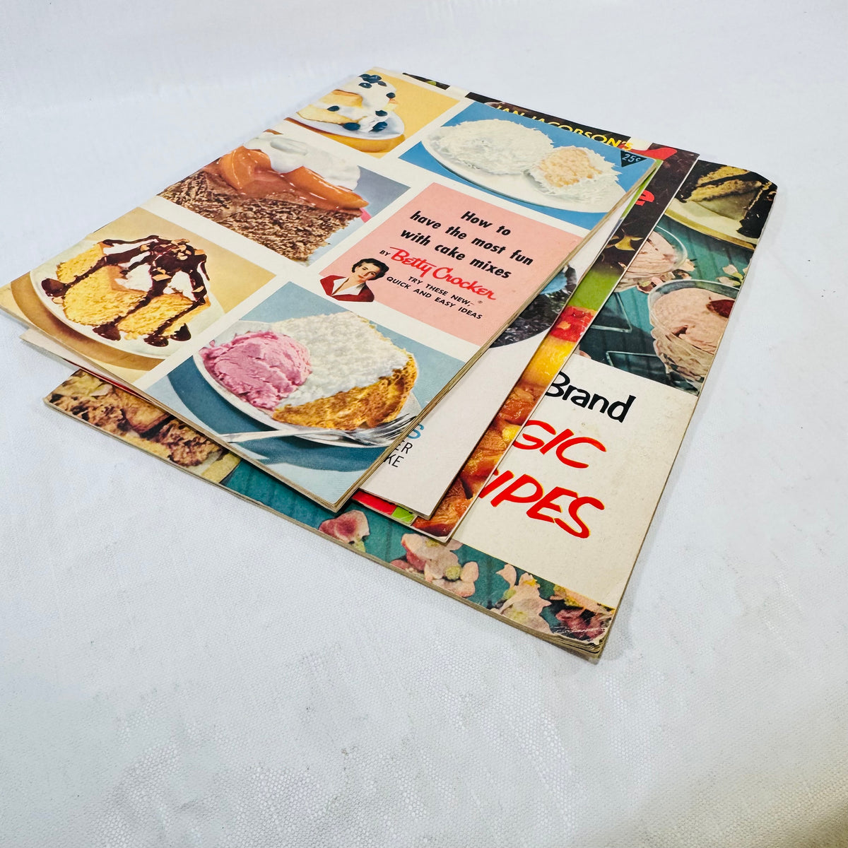 Angled stack of the five vintage recipe pamphlets