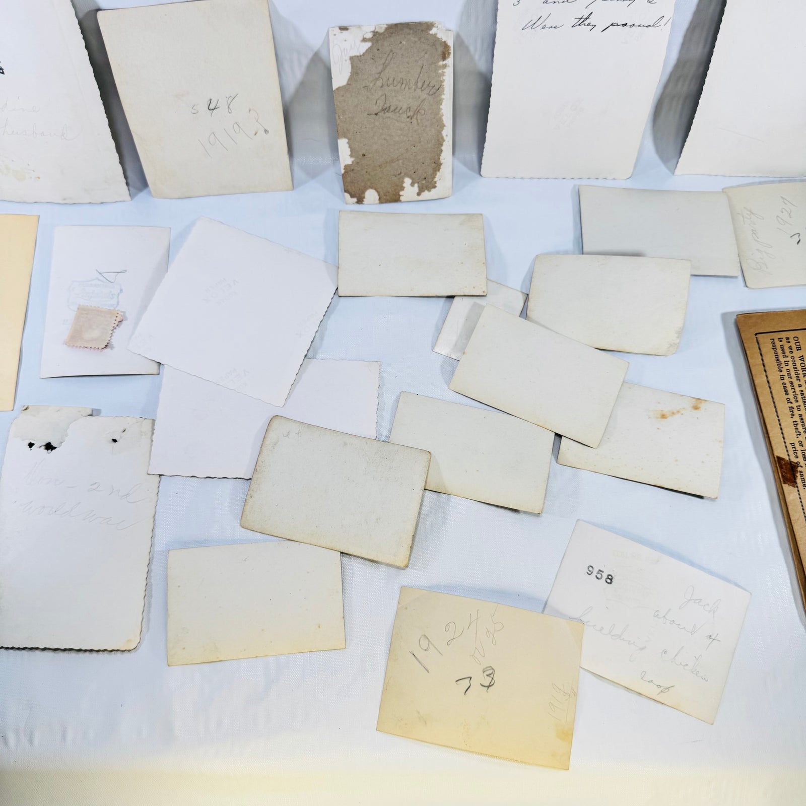 Close-up of photo backs with handwritten dates and album residue