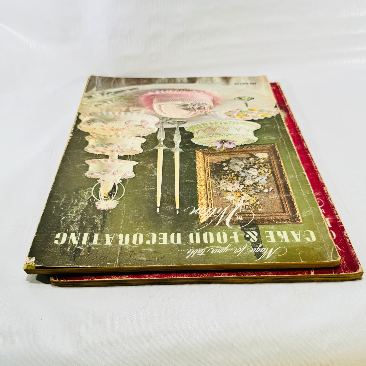 Top edge view of the two Wilton books showing cover and page wear