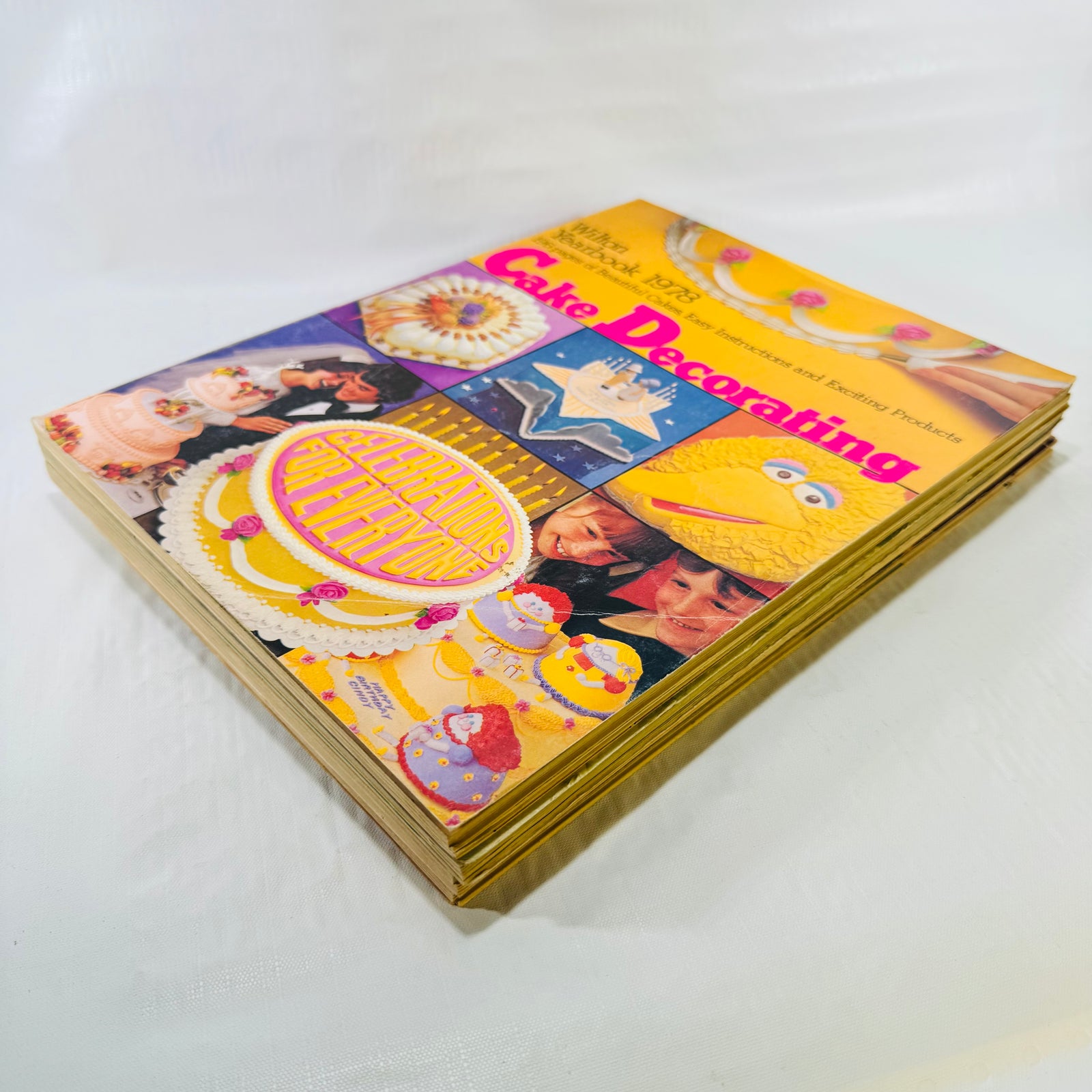 Angled stack of the four Wilton Yearbooks of Cake Decorating