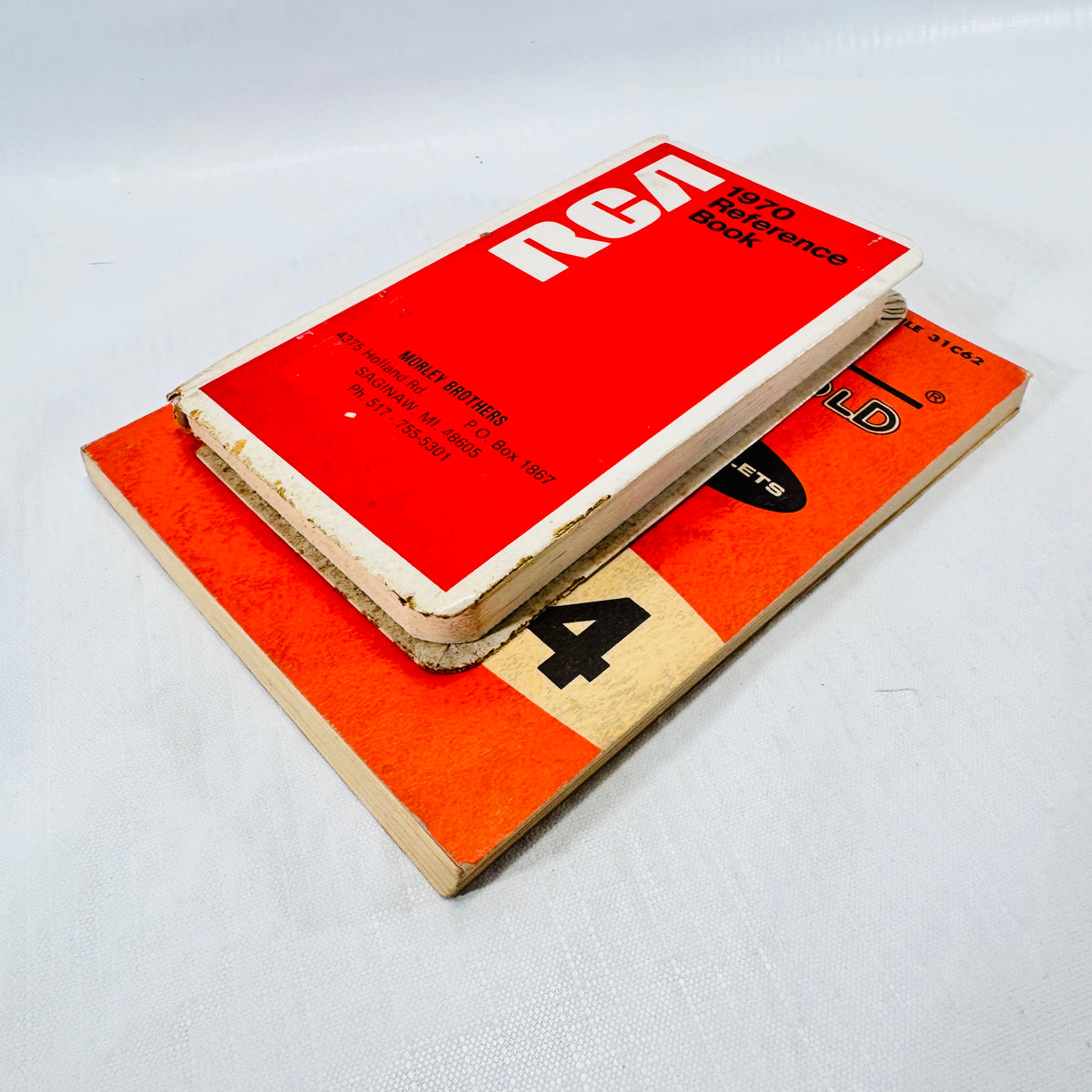 Angled view of the RCA 1970 Reference Book on the Wiremold catalog, showing worn edges with board showing.