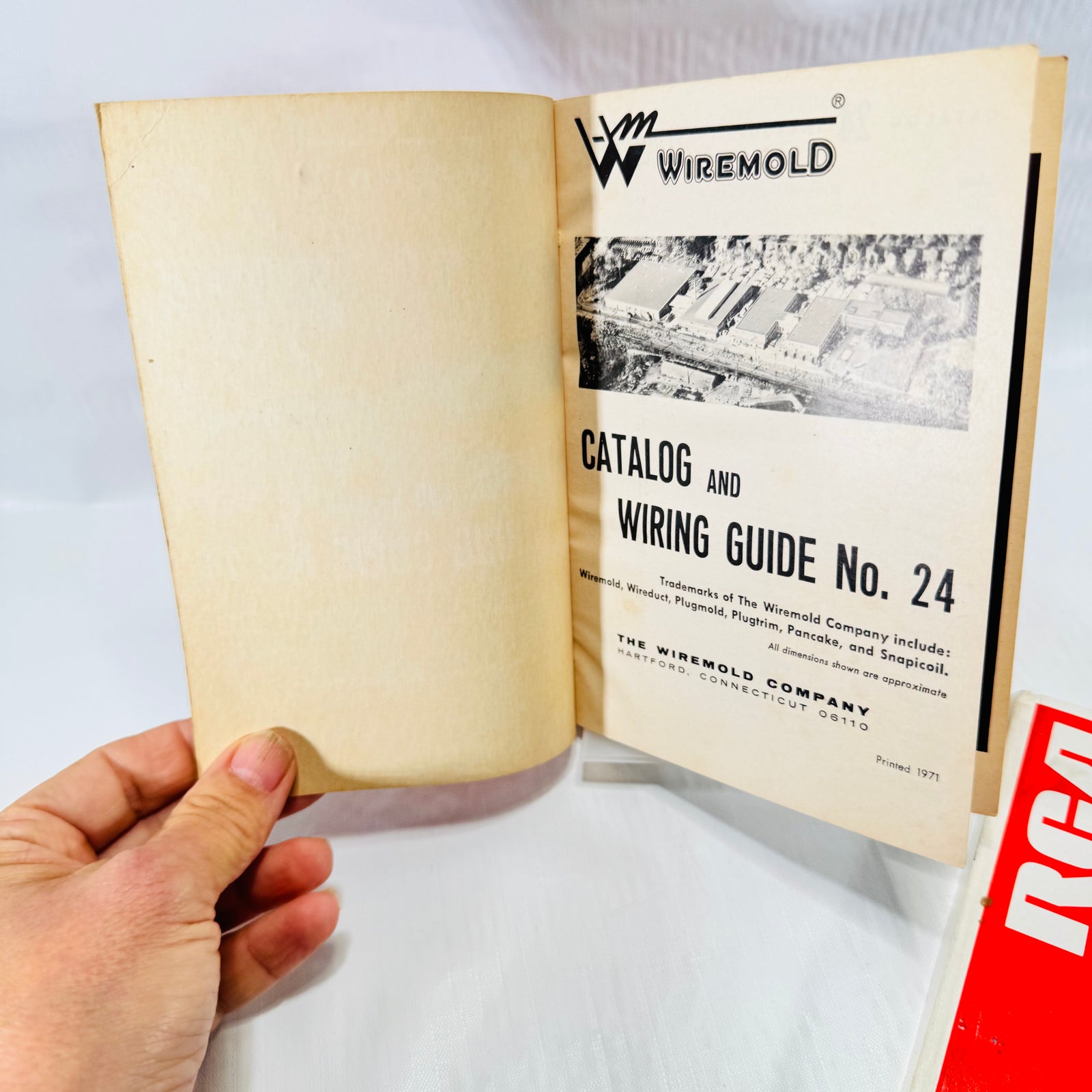 Front covers of the Wiremold Catalog and Wiring Guide No. 24 and the red RCA 1970 Reference Book with Morley Brothers imprint.
