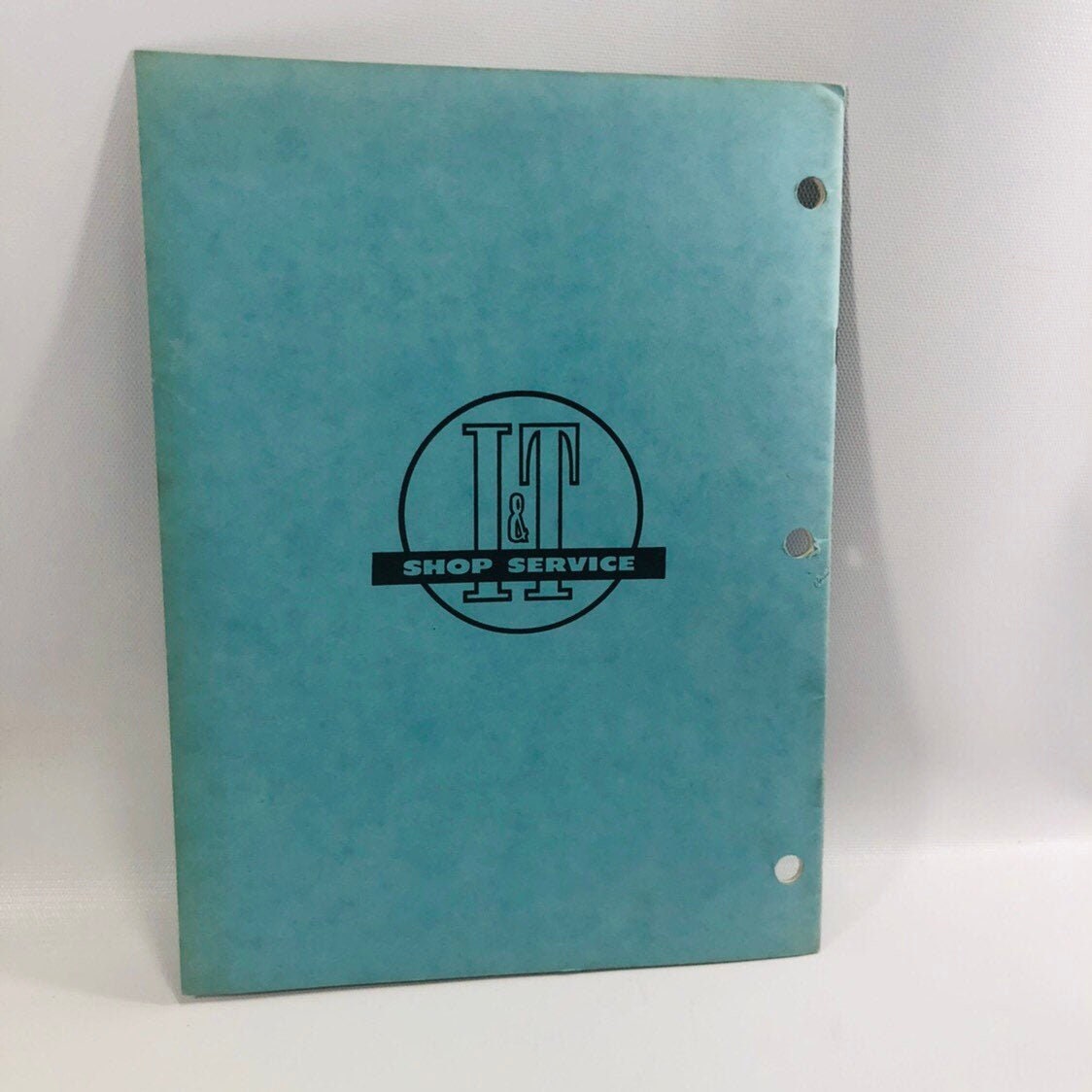 Back cover with the I&T Shop Service logo and binder holes, MM-12 manual 1962