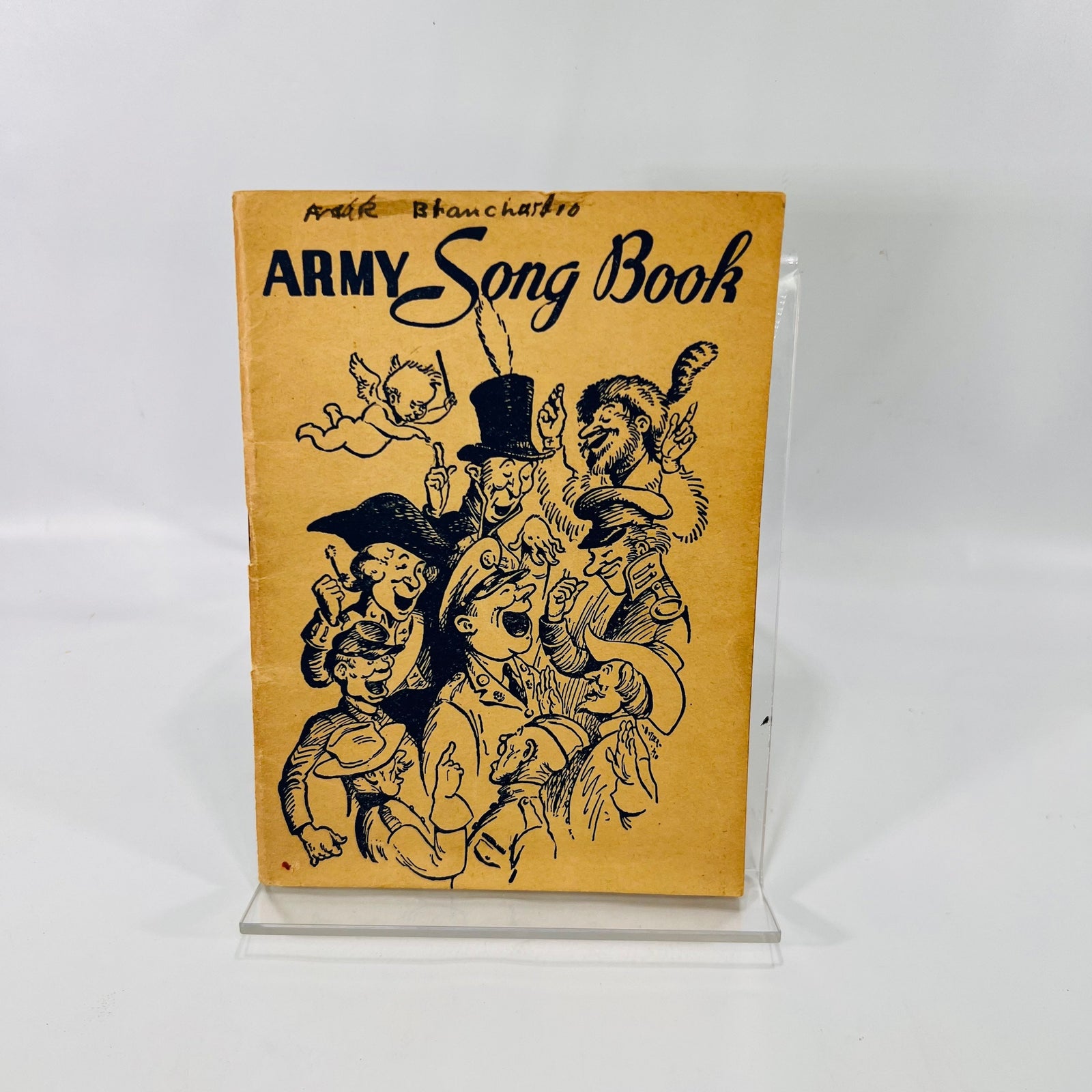 Army Song Book 1941 front cover with cartoon singers and a name in pen